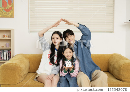 A family lying in bed and doing the calyx pose 125342078