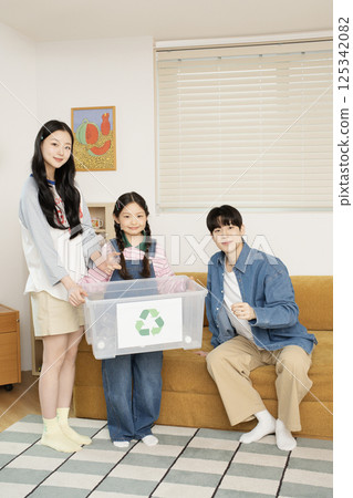 A family taking a photo while lying in bed 125342082
