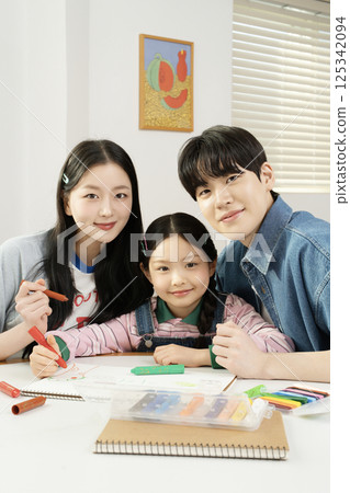 Portrait of a family lying in bed 125342094