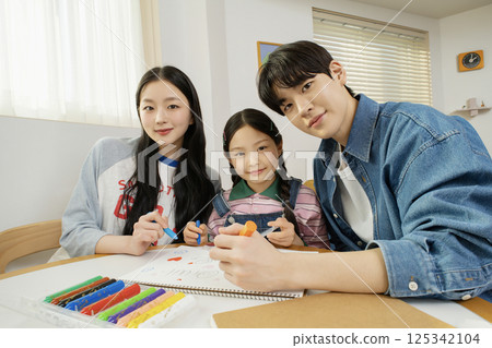 A man sitting on a colorful and cute bed A man sitting on a colorful and cute bed 125342104