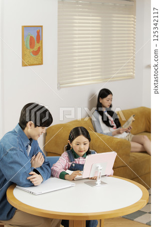 Man listening to music and eating cookies in bed 125342117