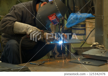 Arc welding - A welder at work 125342476