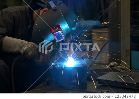 Arc welding - A welder at work 125342478