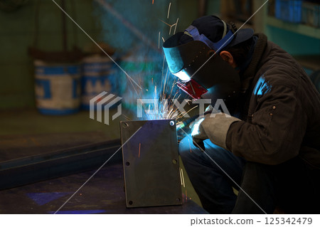Arc welding - A welder at work Arc welding - A welder at work 125342479