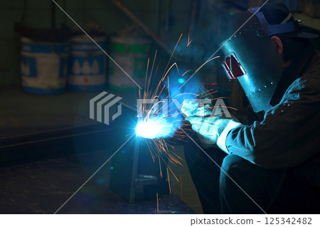 Arc welding - A welder at work 125342482