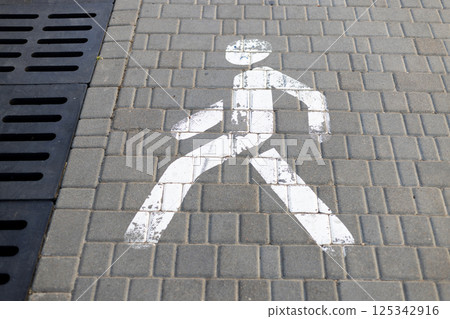 Pedestrian sign on paved walkway 125342916