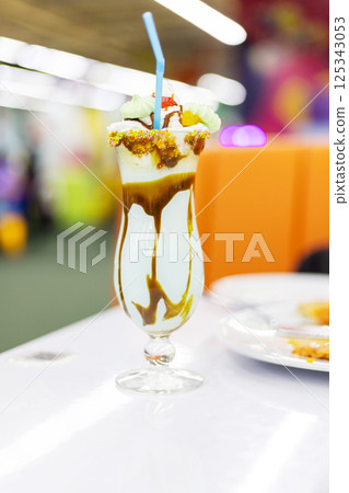 Milkshake with sprinkles and candy topping 125343053