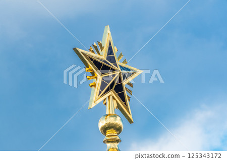 Soviet star emblem of the former Soviet Union-USSR on the tall spire of a vintage building in VDNH exhibition park in Moscow. Soviet star emblem of the former Soviet Union-USSR on the tall spire of a vintage building in VDNH exhibition park in Moscow. 125343172