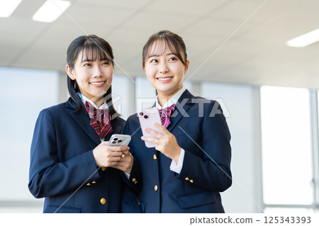 High school girls looking at their smartphones in the classroom. Photo courtesy of Denpa Gakuen, Tokyo Electronics College. High school girls looking at their smartphones in the classroom. Photo courtesy of Denpa Gakuen, Tokyo Electronics College. 125343393