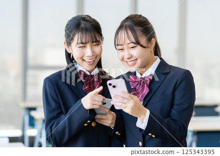 High school girls looking at their smartphones in the classroom. Photo courtesy of Denpa Gakuen, Tokyo Electronics College. High school girls looking at their smartphones in the classroom. Photo courtesy of Denpa Gakuen, Tokyo Electronics College. 125343395