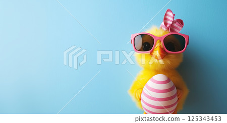 cute yellow chick wearing pink sunglasses and holding striped Easter egg 125343453