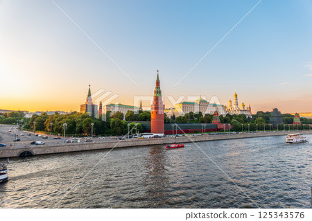 View of Kremlin with Vodovzvodnaya tower, Grand Kremlin Palace from repaired Bolshoy Kamenny Bridge in Moscow city on sunny summer day. Cruise ship sails on the Moscow river View of Kremlin with Vodovzvodnaya tower, Grand Kremlin Palace from repaired Bolshoy Kamenny Bridge in Moscow city on sunny summer day. Cruise ship sails on the Moscow river 125343576