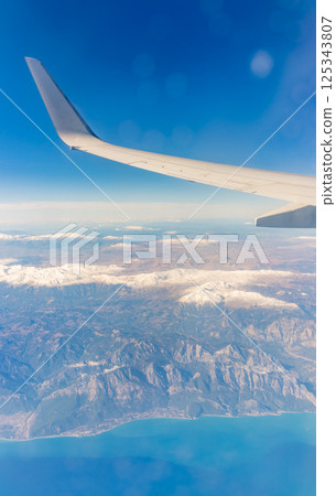 View from the airplane window of the mountains and sea resort with corals in Egypt, Sharm El Sheikh.Flight 125343807