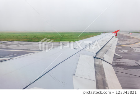 View from the airplane window during taking off on a clear summer morning. Yekaterinburg, Russia 125343821