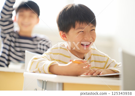 Elementary school boy smiling in the classroom 125343938