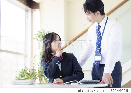 High school students studying at a cram school and their instructor High school students studying at a cram school and their instructor 125344036