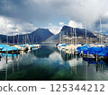 A harbor lined with colorful boats 125344212