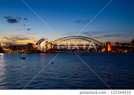 Evening view of the World Heritage Opera House and Harbour Bridge in Sydney, New South Wales, Australia Evening view of the World Heritage Opera House and Harbour Bridge in Sydney, New South Wales, Australia 125344810