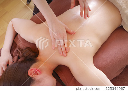 Woman receiving back massage at beauty salon Woman receiving back massage at beauty salon 125344967