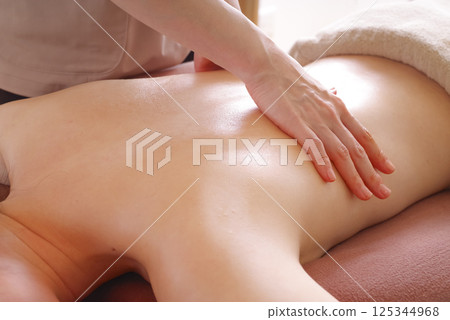 Woman receiving back massage at beauty salon Woman receiving back massage at beauty salon 125344968