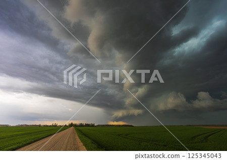 Dark storm rolling through the fields in Lithuania, dark supercell storm clouds Dark storm rolling through the fields in Lithuania, dark supercell storm clouds 125345043