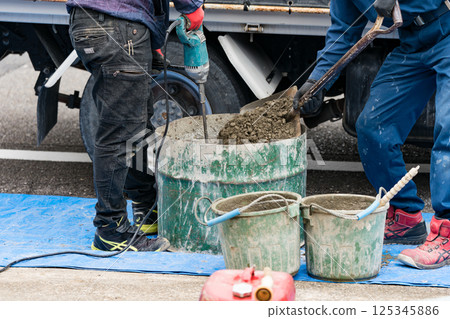 Civil engineer mixing concrete 125345886