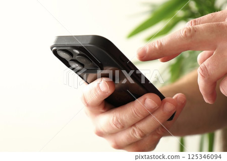 smartphone in hand close up 125346094