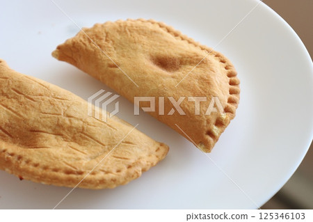 baked crispy pies on a plate baked crispy pies on a plate 125346103