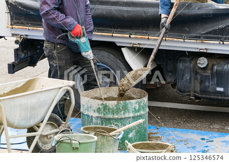 Civil engineer mixing concrete Civil engineer mixing concrete 125346574