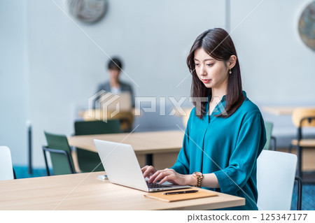 A young woman working in a cafe. A young woman working in a cafe. 125347177