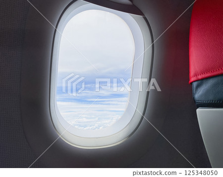 travel and transportation concept with see city and beautiful sky from airplane window 125348050