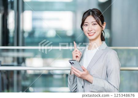 Business woman using a smartphone Business woman using a smartphone 125348676