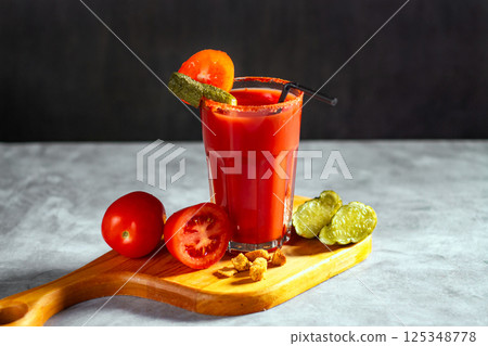 Refreshing vegetable cocktail. Tomato juice served in glass with tomatoes and pickles. Image for menu, bars, restaurants Refreshing vegetable cocktail. Tomato juice served in glass with tomatoes and pickles. Image for menu, bars, restaurants 125348778