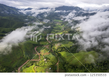 Landscape of Morning Mist with Mountain Layer. mountain ridge and clouds in rural jungle bush forest Landscape of Morning Mist with Mountain Layer. mountain ridge and clouds in rural jungle bush forest 125350533