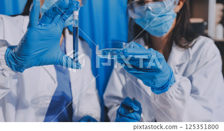 Researcher using a professional microscope Researcher using a professional microscope 125351800