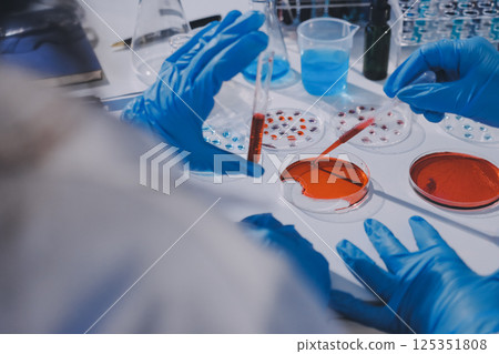 Researcher using a professional microscope Researcher using a professional microscope 125351808