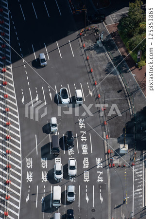 Looking down at cars waiting at a traffic light 125351865