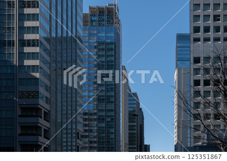 Skyscrapers towering over the blue sky 125351867