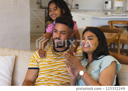Happy family enjoying quality time together on cozy living room sofa Happy family enjoying quality time together on cozy living room sofa 125352249