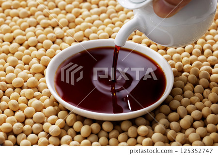 Soybeans and soy sauce poured into a bowl Soybeans and soy sauce poured into a bowl 125352747