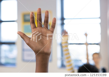 Raising hand in classroom, african american boy actively participating in school lesson 125353199