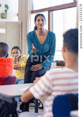In school, Indian female teacher engaging with students, fostering interactive learning environment In school, Indian female teacher engaging with students, fostering interactive learning environment 125353276