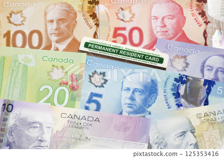 American permanent resident card on a Canadian money 125353416