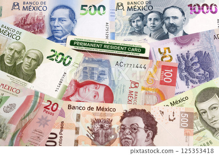 American permanent resident card on a Mexican money American permanent resident card on a Mexican money 125353418