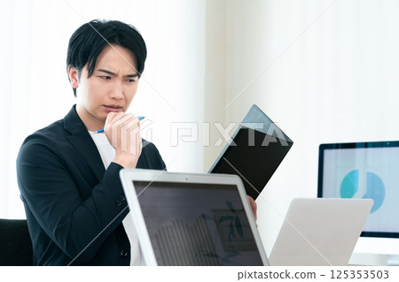 Casual style businessman checking documents 125353503