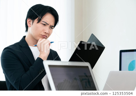 Casual style businessman checking documents 125353504