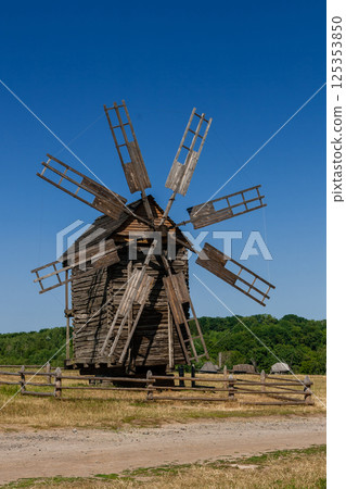 Old windmill on blue sky background 125353850