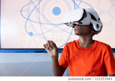 Using VR headset, student exploring virtual reality in school classroom Using VR headset, student exploring virtual reality in school classroom 125353983