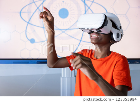 Using VR headset, student in school engaging with virtual reality experience Using VR headset, student in school engaging with virtual reality experience 125353984