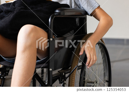 Holding wheel, student in wheelchair attending school activities Holding wheel, student in wheelchair attending school activities 125354053